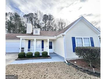 Charming single-story home with blue shutters, a covered porch, and well-maintained landscaping in the front yard at 3353 Medina Dr, Jonesboro, GA 30236