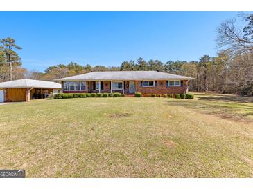Charming ranch-style brick home with a spacious front yard and mature trees at 275 S Bethany Rd, Mcdonough, GA 30252