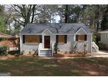 Charming brick home featuring a welcoming front entrance and meticulously maintained landscaping at 2096 Dellwood Pl, Decatur, GA 30032