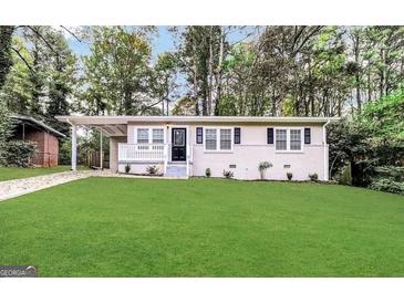 Charming single-story home boasts a well-manicured lawn and inviting carport at 3037 San Juan Dr, Decatur, GA 30032