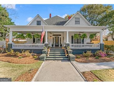 Charming home features an inviting front porch, manicured lawn, and classic architectural details at 2173 Conyers Se St, Covington, GA 30014