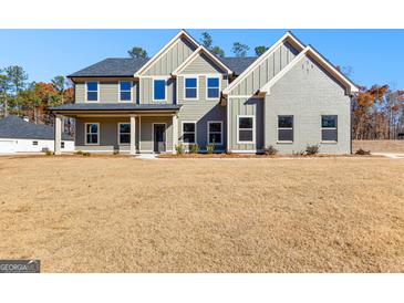 Charming two-story home featuring a mix of gray siding and brick, complemented by a well-maintained lawn at 279 Deer Creek Run # 4, Moreland, GA 30259