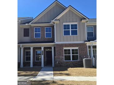 Charming brick and siding home with covered porch, perfect for enjoying the outdoors at 4849 Walkers Green, Mableton, GA 30126