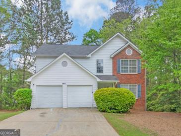 Charming two-story home with a two-car garage and well-maintained landscaping at 10018 Clearwater Trl, Jonesboro, GA 30238