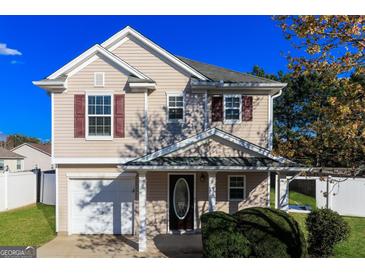 Inviting two-story home with a covered entryway, well-maintained lawn, and attractive curb appeal at 312 Silver Fox Trl, Dallas, GA 30157