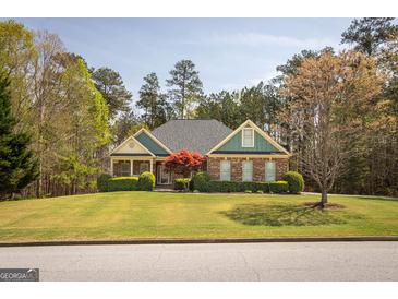 Charming brick home with mature landscaping and a lush green lawn, creating curb appeal at 50 Clear Spring Ct, Oxford, GA 30054