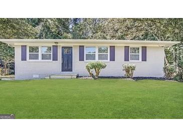 Charming single-story home with a well-maintained lawn and beautiful landscaping at 3410 Nw Adkins Rd, Atlanta, GA 30331