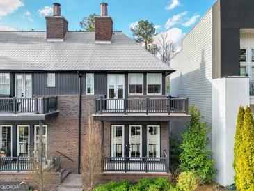 Charming brick townhouse with a cozy balcony and well-maintained landscaping at 434 Selborne Way, Chattahoochee Hills, GA 30268