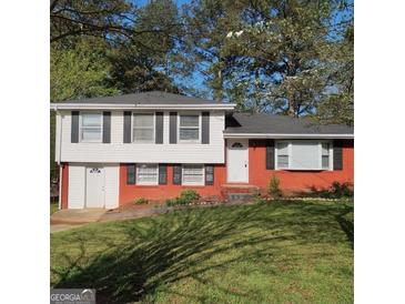 Charming two-story home with a well-maintained lawn and traditional architecture at 6521 King William Dr, Morrow, GA 30260