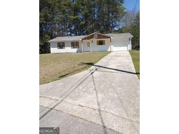 Charming one-story home with a well-maintained lawn and a long concrete driveway at 1172 Sheffield Ct, Jonesboro, GA 30238