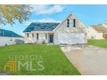 Charming single-Gathering home featuring a well-manicured lawn, neutral siding, and an attached two-car garage at 173 Regency Park Dr, Mcdonough, GA 30253