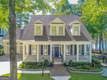 Charming two-story home with a welcoming front porch, well-manicured lawn, and mature trees at 504 Telfair Park, Peachtree City, GA 30269