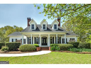 Stately two-story home with dormer windows, brick chimneys, and a manicured lawn at 935 Amelia Rd, Locust Grove, GA 30248
