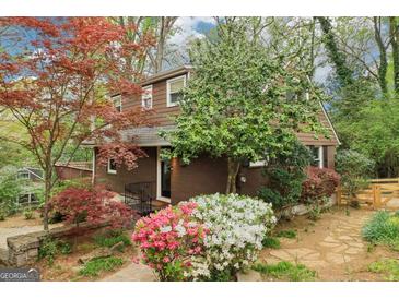 Charming two-story home featuring brick siding and well-manicured landscaping at 2891 Ridgemore Nw Rd, Atlanta, GA 30318