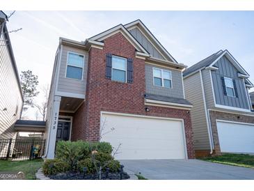 Charming two-story home with a brick facade and an attached two-car garage at 1735 Labonte Pkwy, Mcdonough, GA 30253