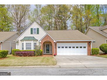 Charming single-Gathering home featuring a two-car garage and a well-manicured front yard at 1010 Pinehurst Dr, Peachtree City, GA 30269