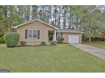 Charming single-story home featuring a well-manicured lawn and cozy curb appeal at 212 Bella Rosa, Peachtree City, GA 30269