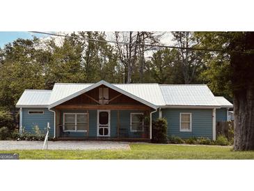 Charming single story home featuring metal roof, welcoming porch and classic curb appeal at 6121 N Main Se St, Acworth, GA 30101