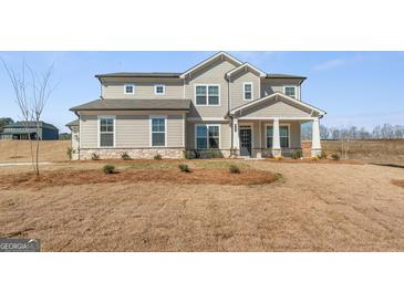 Inviting two-story home featuring a covered porch, neutral siding, and well-manicured landscaping at 315 Arwen Dr # 105, Mcdonough, GA 30252