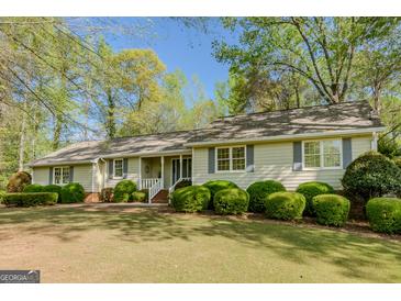 Charming single-story home with manicured lawn and mature landscaping, great curb appeal at 115 Bob White Trl, Fayetteville, GA 30215