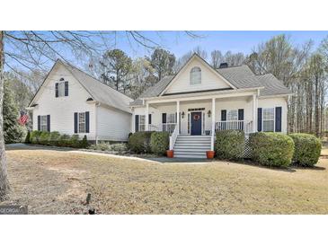 Charming white two-story home with a welcoming front porch and manicured landscaping at 35 Ryans Ct, Sharpsburg, GA 30277
