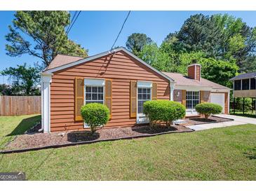 Charming single-story home featuring wood-look siding, shutters, and well-maintained landscaping at 4691 Garden Hills Ct, Stone Mountain, GA 30083