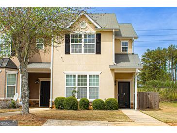 Charming two-story home with a manicured lawn, well-placed shrubbery, and a welcoming front porch, creating great curb appeal at 304 Commons Dr, Jonesboro, GA 30236