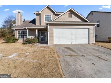 Two-story home with a two-car garage and a front porch at 5728 Rock Shoals Way, Atlanta, GA 30349