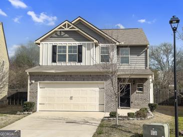 Charming two-story home featuring a brick and siding facade, a two-car garage, and well-maintained landscaping at 789 Galveston Way, Mcdonough, GA 30253