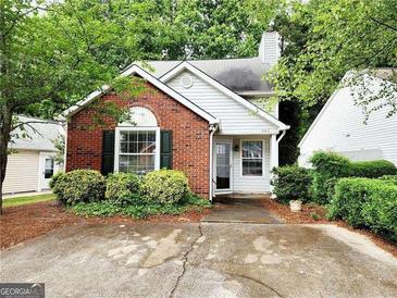 Charming home featuring brick accents, manicured landscaping, and inviting curb appeal in a tranquil neighborhood setting at 645 Crossbridge Aly, Johns Creek, GA 30022