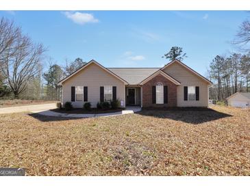 Charming single-story home with a well-maintained front yard and a mix of vinyl siding and brick facade at 321 Harris Ave, Locust Grove, GA 30248