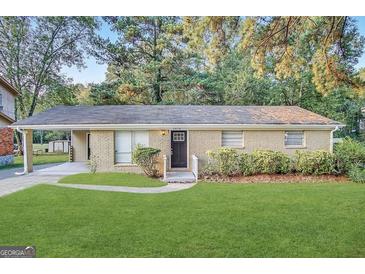 Charming brick home with a well-manicured lawn and attached carport at 3578 Sherbrooke Sw Way, Atlanta, GA 30331