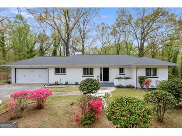 Charming one-story home with fresh exterior paint and lush landscaping with flowering bushes at 2694 Benjamin E Mays Sw Dr, Atlanta, GA 30311