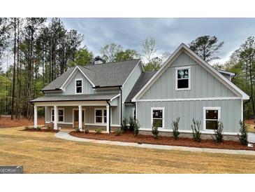 Charming home with a welcoming front porch and meticulously landscaped front yard at 4585 Parkwood Rd, Social Circle, GA 30025