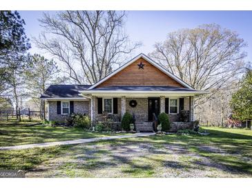 Charming brick home with a welcoming front porch and well-maintained landscaping at 689 Hardin Rd, Temple, GA 30179