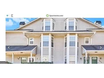Inviting two-story townhouse featuring traditional architectural details and manicured landscaping at 9453 Cypress Ln, Jonesboro, GA 30238