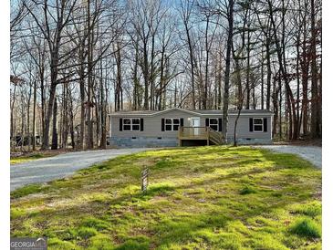 Charming one-story home with a covered front porch and well-maintained lawn at 54 Holly Dr, Carrollton, GA 30116