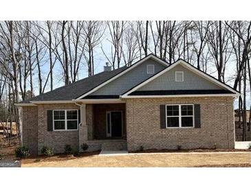 Charming, new construction, one-story home featuring a brick facade and a classic gabled roofline with gray accents at 3383 Milan Ct # 4 Plapprox Sqft 1, Douglasville, GA 30135
