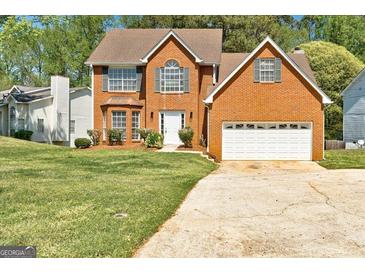 Charming two-story brick home with well-maintained lawn and attached two-car garage at 3612 River Mill Ct, Ellenwood, GA 30294
