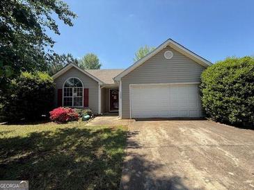 Charming single-story home featuring a well-maintained yard, a two-car garage, and inviting curb appeal at 10119 Commons Way, Jonesboro, GA 30238