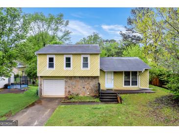 Charming two-story home with a stone facade, attached garage, and a well-maintained front yard at 3121 Cruse Rd, Lawrenceville, GA 30044