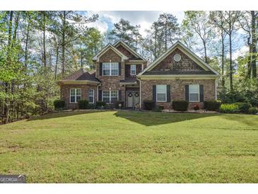 Charming brick home with a manicured lawn and mature trees at 4360 Derrick Rd, South Fulton, GA 30349
