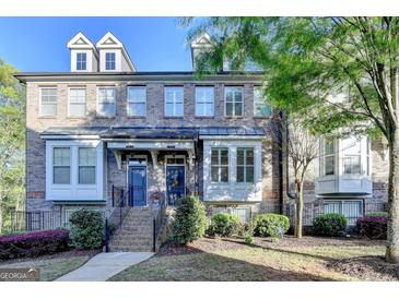 Charming brick townhome with well-manicured landscaping and inviting entryway at 7920 Willoughby Ct, Alpharetta, GA 30005