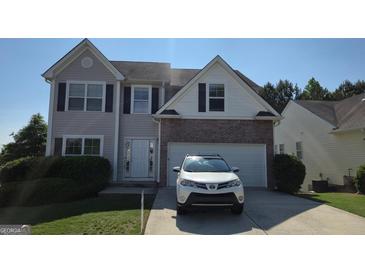 Charming two-story home featuring neutral siding, brick accents, and a well-maintained front yard at 771 Franklin Mill Trce, Loganville, GA 30052