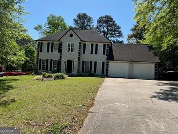 Traditional two-story home with attached two car garage and well maintained landscaping at 1164 Interlaken Pass, Jonesboro, GA 30238