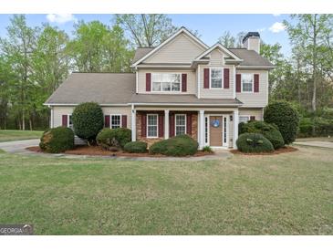 Charming two-story home featuring manicured landscaping, a welcoming entrance, and a classic architectural design at 225 Briarsweet Way, Fayetteville, GA 30215