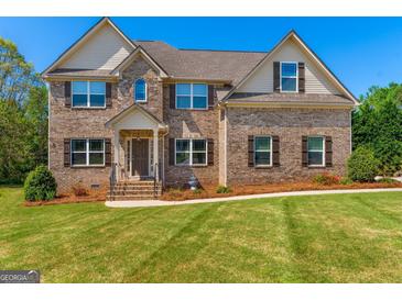 Charming two-story brick home with well-manicured lawn and a welcoming entrance at 4402 Kady Ct, Mcdonough, GA 30252