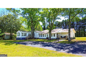 Charming single-story home with mature trees and a well-maintained lawn at 20 Rosser Rd, Mcdonough, GA 30252