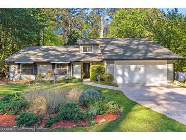 Charming home with lush landscaping, a gray roof, and inviting curb appeal at 203 Silverwood Way, Peachtree City, GA 30269