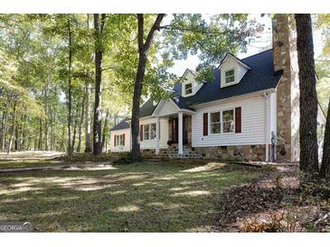 Charming two-story home featuring dormer windows, stone accents, and a well-manicured lawn at 230 Haynes Rd, Moreland, GA 30259